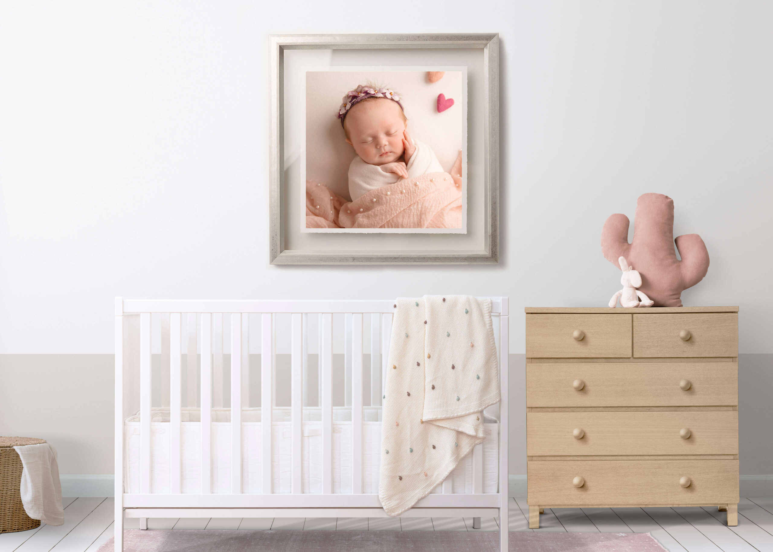 new born baby photoshoot, wrapped in soft blankets, hanging on the wall of her bedroom.