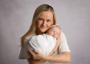 Mother and baby posing for professional baby photos, captured by your expert baby photographer, Chani Spiro.
